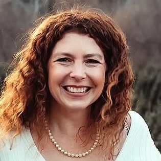 Picture of a smiling woman with long, curly hair
