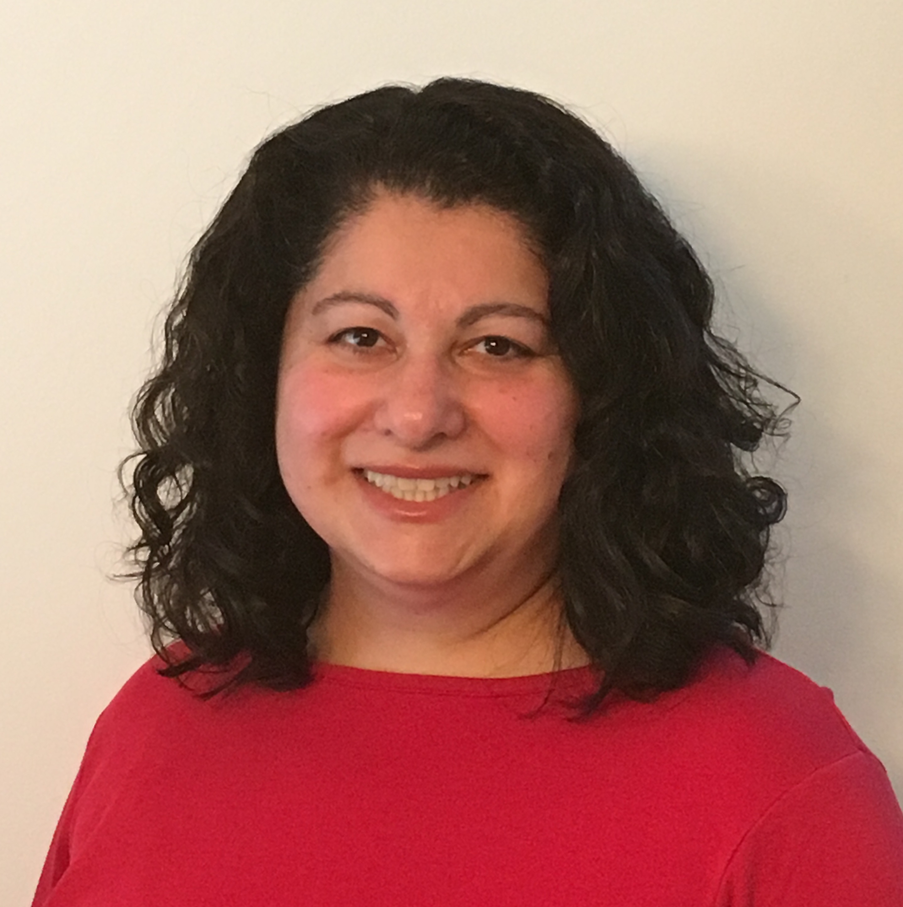 Woman with black hair, light brown complexion, and red shirt