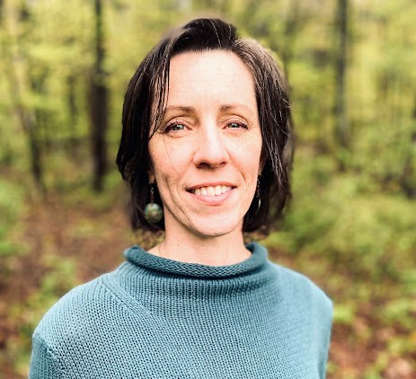 Woman headshot with trees behind