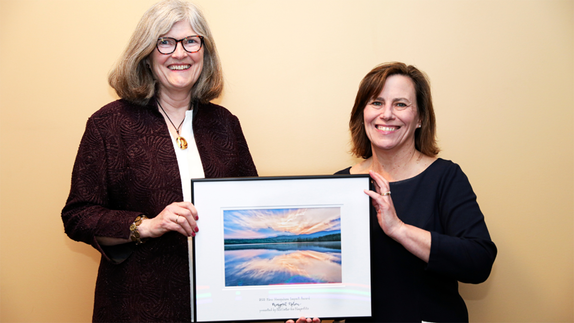 Margaret Nelson accepting an Impact Award from Kathleen Reardon